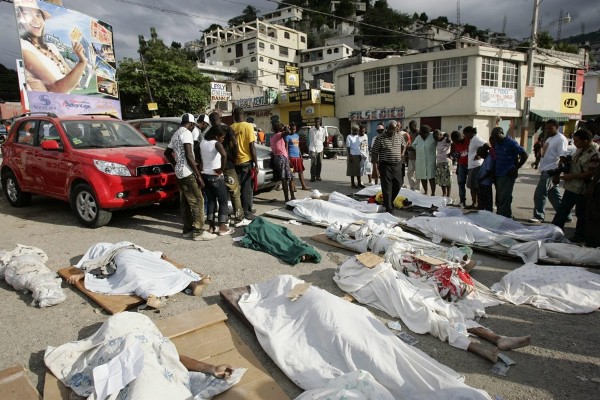 Unas personas observan varios cuerpos sin vida en Puerto Príncipe.