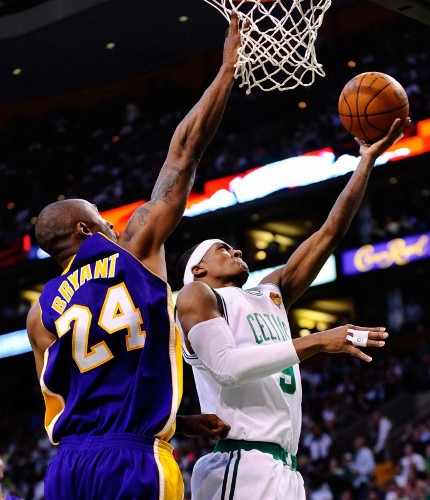 El jugador de los Celtics de Boston Rajon Rondo (d) lanza ante Kobe Bryant (i) de los Lakers.