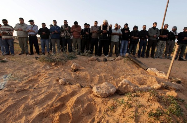 Rebeldes libios oran durante el entierro de un camarada.