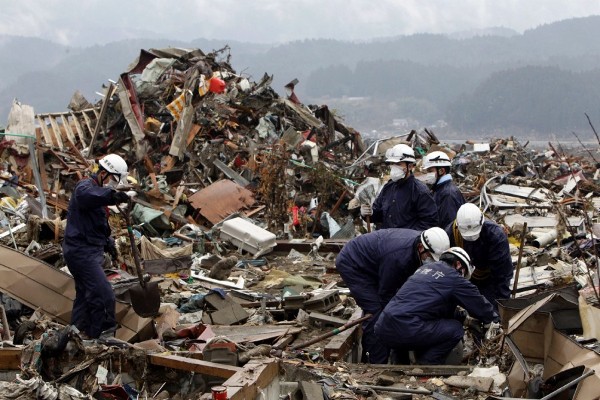 Policías buscan entre los escombros en la ciudad devastada de Rikuzentakata.