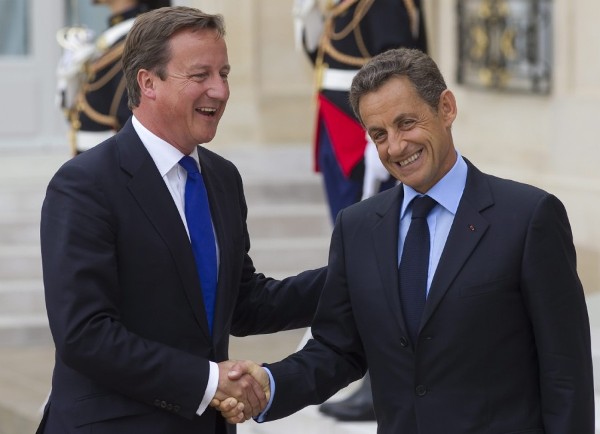 El primer ministro británico David Cameron (izda) saluda al presidente francés Nicolas Sarkozy.