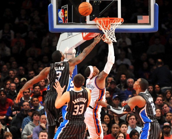 El alero Carmelo Anthony (2d), de los New York Knicks, entra a canasta delante de Earl Clark.
