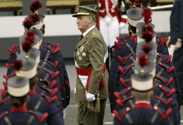 El rey Juan Carlos pasa revista a las tropas que le han rendido honores, momentos antes del inicio del desfile militar, organizado hoy en Madrid con motivo de la celebración de la Fiesta Nacional.