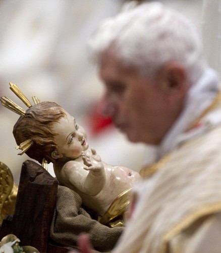 El papa Benedicto XVI camina frente a una imagen del niño Jesús durante la misa de Navidad.