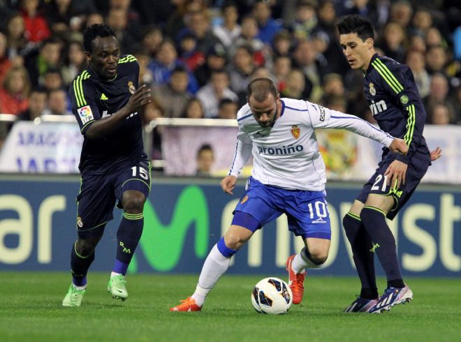 Apoño (c) pelea un balón con los jugadores del Real Madrid Michael Essien (i) y José Callejón.