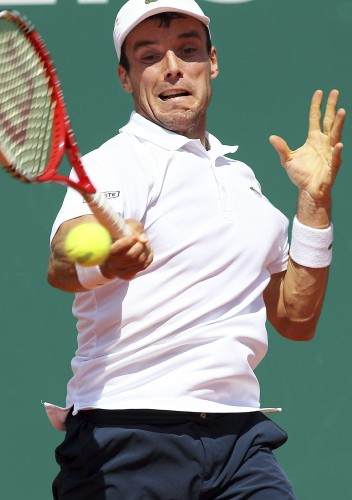 El tenista español Roberto Bautista Agut devuelve la bola ante el francés Gilles Simon durante su encuentro de la primera ronda del torneo ATP de Montecarlo celebrado en Roquebrune-Cap-Martin, Francia.