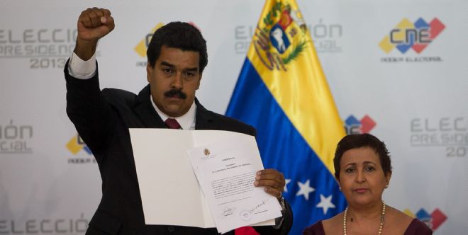 El gobernante encargado y candidato del oficialismo, Nicolás Maduro, saluda tras ser proclamado como presidente de Venezuela.