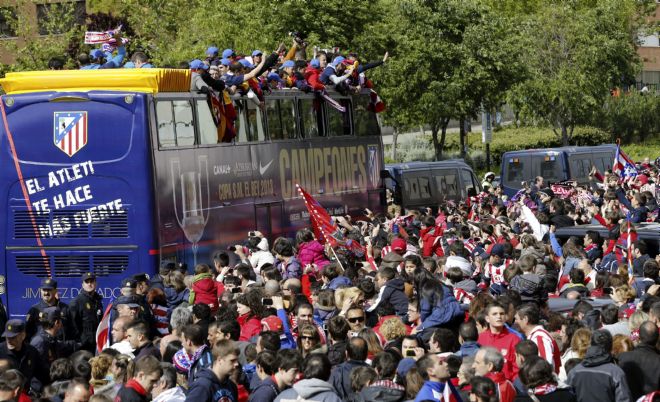 Los jugadores y componentes del cuerpo técnico del Atlético de Madrid subidos en autobús descapotable.