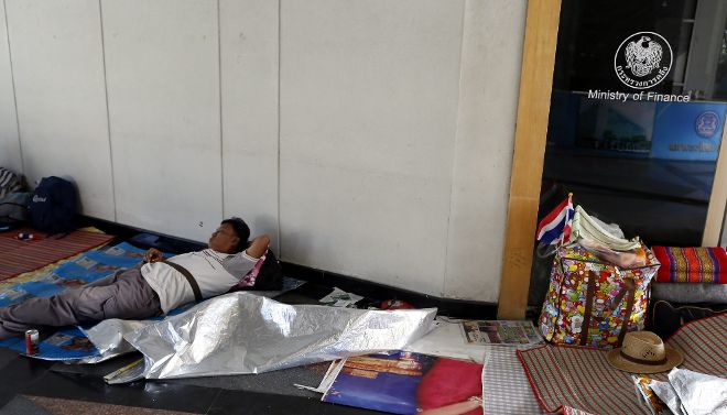 Un grupo de manifestantes descansa dentro del edificio del Ministerio de Finanzas que ocuparon hoy, viernes 6 de diciembre de 2013, en Bangkok (Tailandia). El líder de la protesta en contra del gobierno, Suthep Thaugsuban, juró que seguirá luchando para derrocar el gobierno del primer ministro Yingluck Shinawatra a pesar del llamado a la unidad que hizo el rey de Tailandia.
