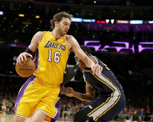 Los Angeles Lakers Pau Gasol of Spain (L) spins away from Utah Jazz defender Derrick Favors (R) in the first half action of their NBA game at Staples Center in Los Angeles, California USA, 03 January 2014.