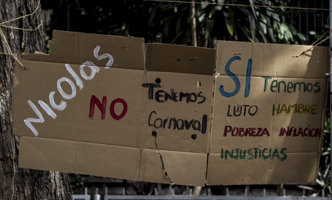 Detalle de mensajes escritos en un cartón contra el Gobierno de Nicolás Maduro en una calle de Caracas.