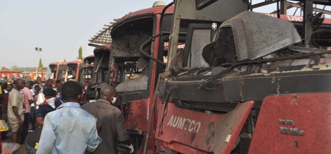 Algunos ciudadanos observan daños en varios vehículos tras una explosión en la estación de autobuses Nyana a las afueras de Abuya (Nigeria).