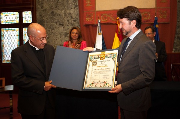 El deán de la catedral de La Laguna recibe la distinción de manos del presidente del Cabildo, Carlos Alonso.