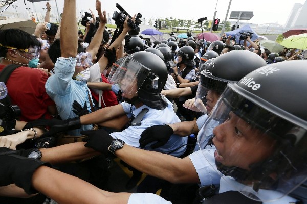 Agentes de la policía contienen a los manifestantes que bloquean el acceso a edificios gubernamentales.
