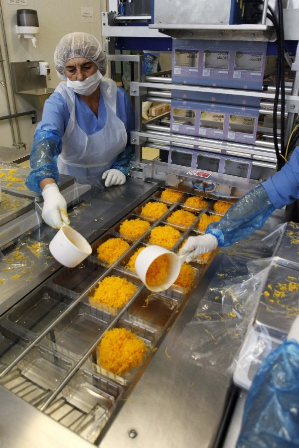 Operarios de la empresa abulense Yemas de Santa Teresa trabajan en la elaboración del huevo hilado.