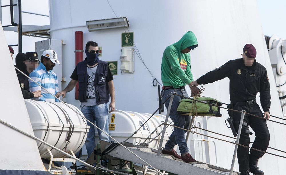 Agentes de la Policía desembarcan a los tripulantes del pesquero "Coral I", que fue interceptado con 1.500 kilos de cocaína el pasado 5 de enero en aguas del Atlántico, a 80 millas al oeste de Cabo Verde, tras atracar hoy en la Base Naval de Las Palmas.