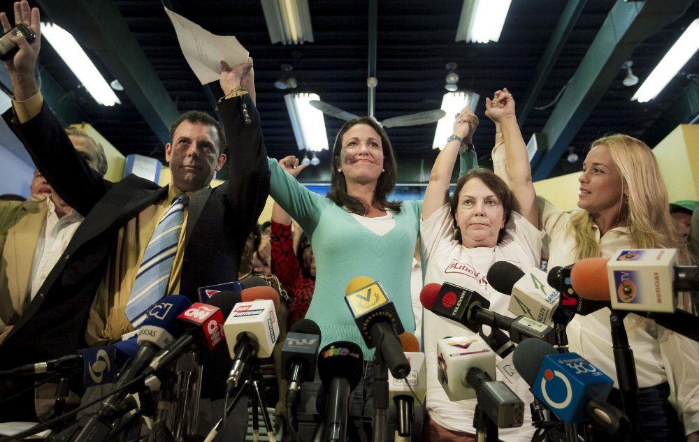 De izquierda a derecha, el presidente del partido político Copei, Roberto Enríquez, la exdiputada María Corina Machado, Mitzy Capriles, esposa del alcalde mayor de Caracas, y Lilian Tintori, esposa del líder político Leopoldo López.