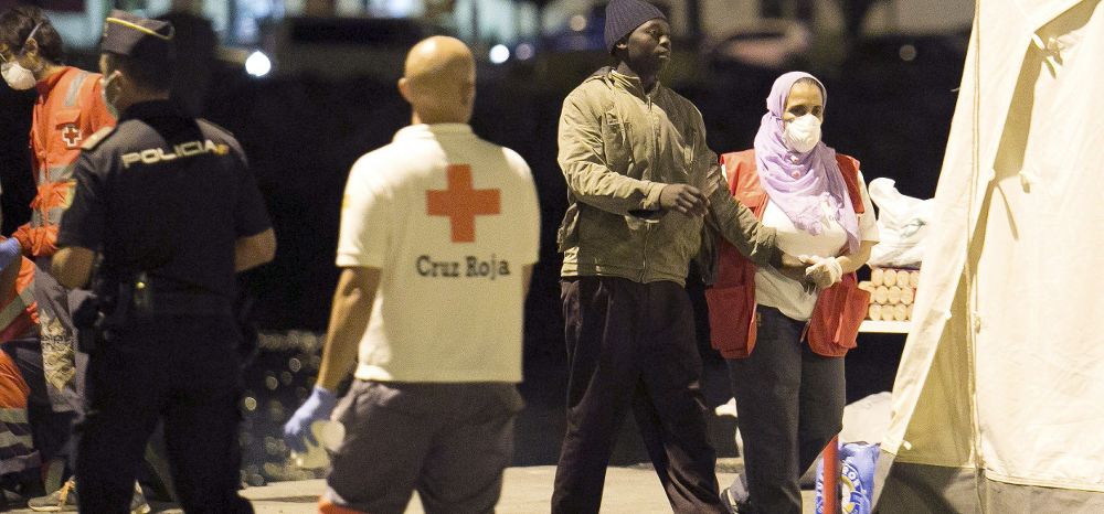 Miembros de la cruz roja ayudan a uno de los 43 inmigrantes subsaharianos rescatados por Salvamento Marítimo, a su llegada al puerto del Rosario en Fuerteventura, cuando navegaban en una patera localizada a 79 millas (146 kilómetros) al este de la isla.