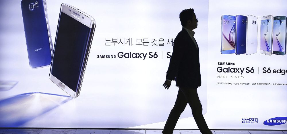 Un surcoreano camina junto a un cartel publicitario del Samsung S6.