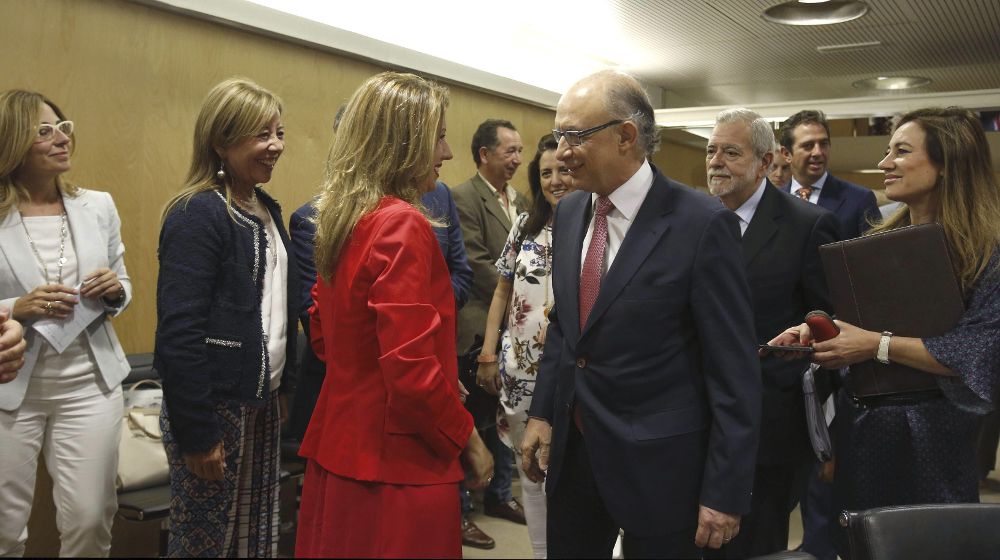 El ministro de Hacienda y Administraciones Públicas, Cristóbal Montoro (c-d) saluda a la consejera de Hacienda de Canarias, Rosa Dávila (de rojo), durante su asistencia al Consejo de Política Fiscal y Financiera (CPFF), esta tarde en Madrid.