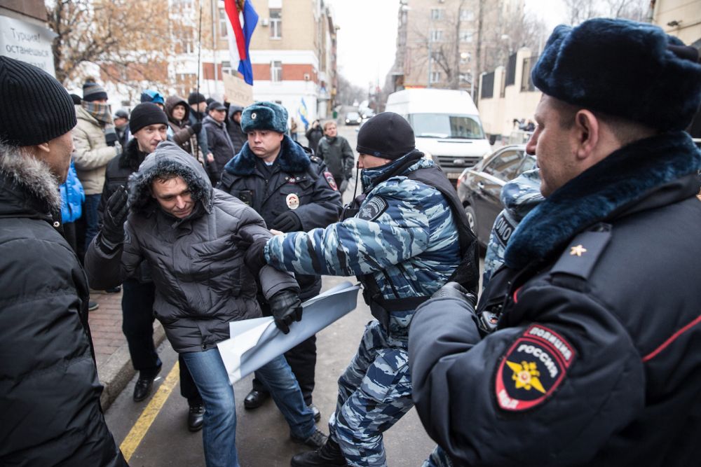 La policía detiene a uno de los manifestantes que protestan delante de la Embajada de Turquía en Moscú por el derribo del bombardero ruso Su-24.