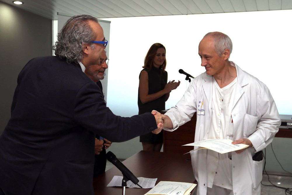 El consejero de sanidad del Gobierno de Canarias, Jesús Morera (i), entrega al médico e investigador de oncología del Hospital Doctor Negrín de Gran Canaria, Bernardino Clavo, uno de los premios de investigación médico 2015 que otorga la Fundación Disa.