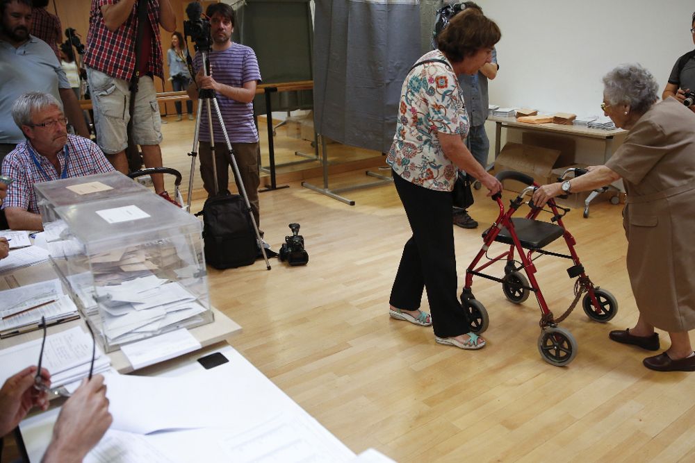 Una anciana se dirige a ejercer su derecho al voto en un colegio electoral de la localidad de Pozuelo de Alarcón, en Madrid.