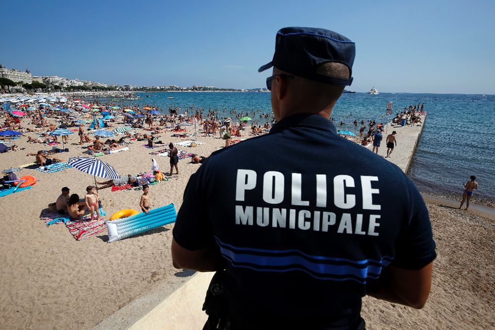 La policía patrulla por la playa de Cannes.