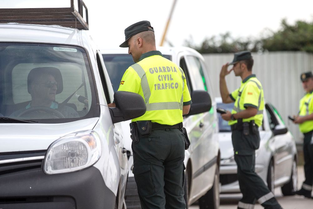 Varios agentes de la Guardia Civil de Tráfico realizan un control, en la vía de servicio de la V-31 cerca de Valencia.
