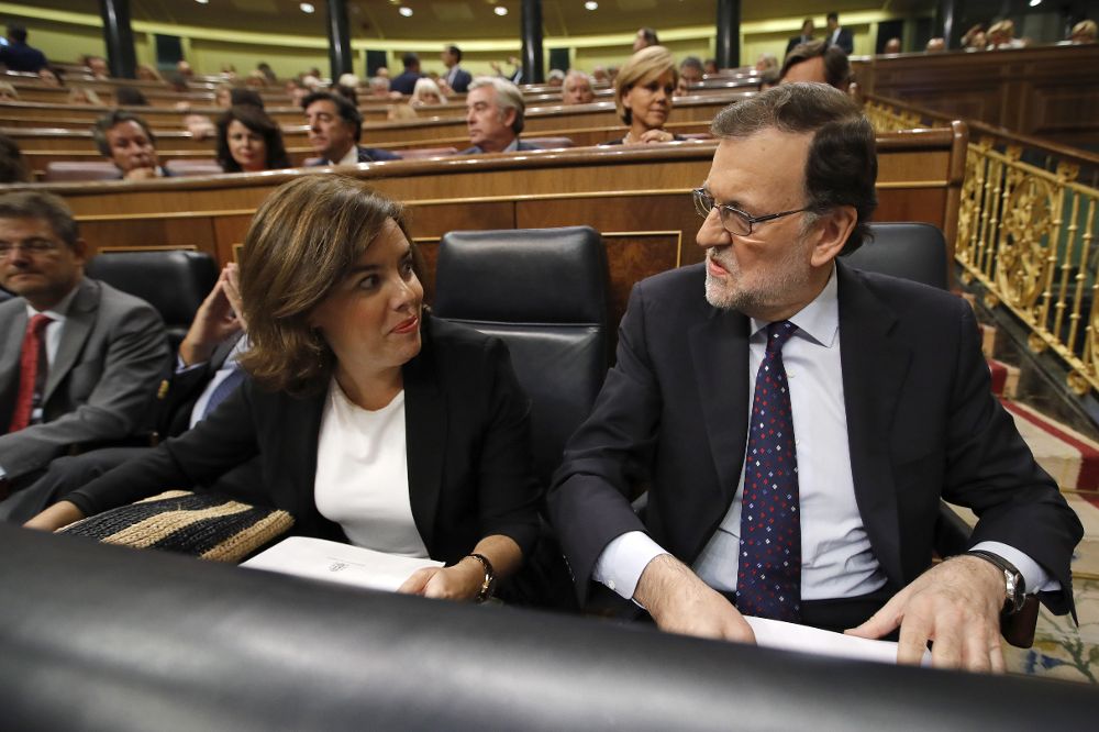 El presidente del Gobierno en funciones, Mariano Rajoy (d) conversa con la vicepresidenta del Gobierno en funciones, Soraya Sáenz de Santamaría (i).