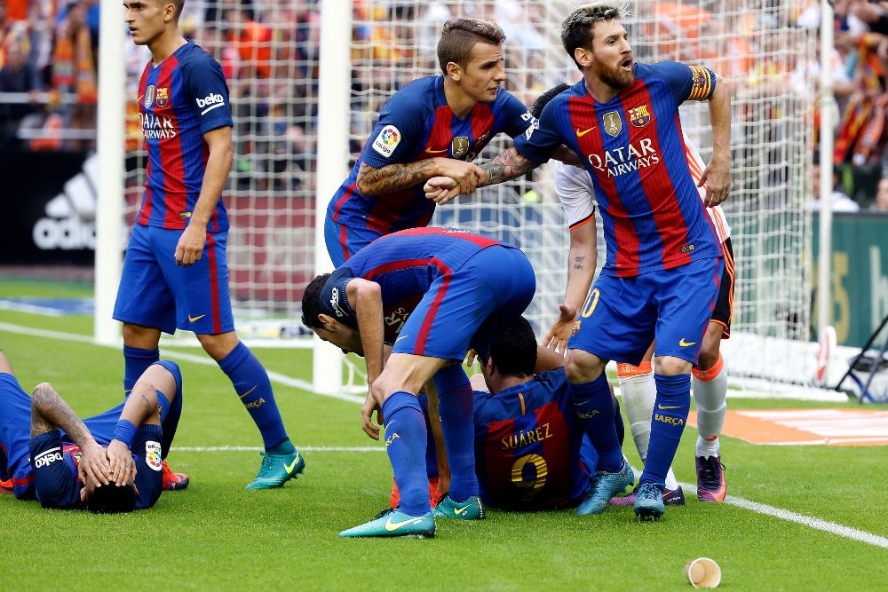 El delantero argentino del FC Barcelona Leo Mesi (d), se encara con la grada después de que caigan botellas sobre los jugadores culés.