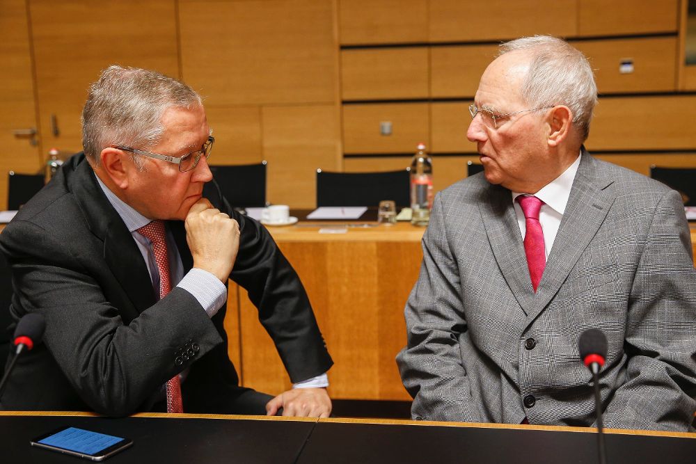El ministro de Finanzas alemán, Wolfgang Schäuble (d), habla con el director gerente del fondo de rescate de la eurozona, Klaus Regling, al inicio de la reunión de los ministros del Ecofin.