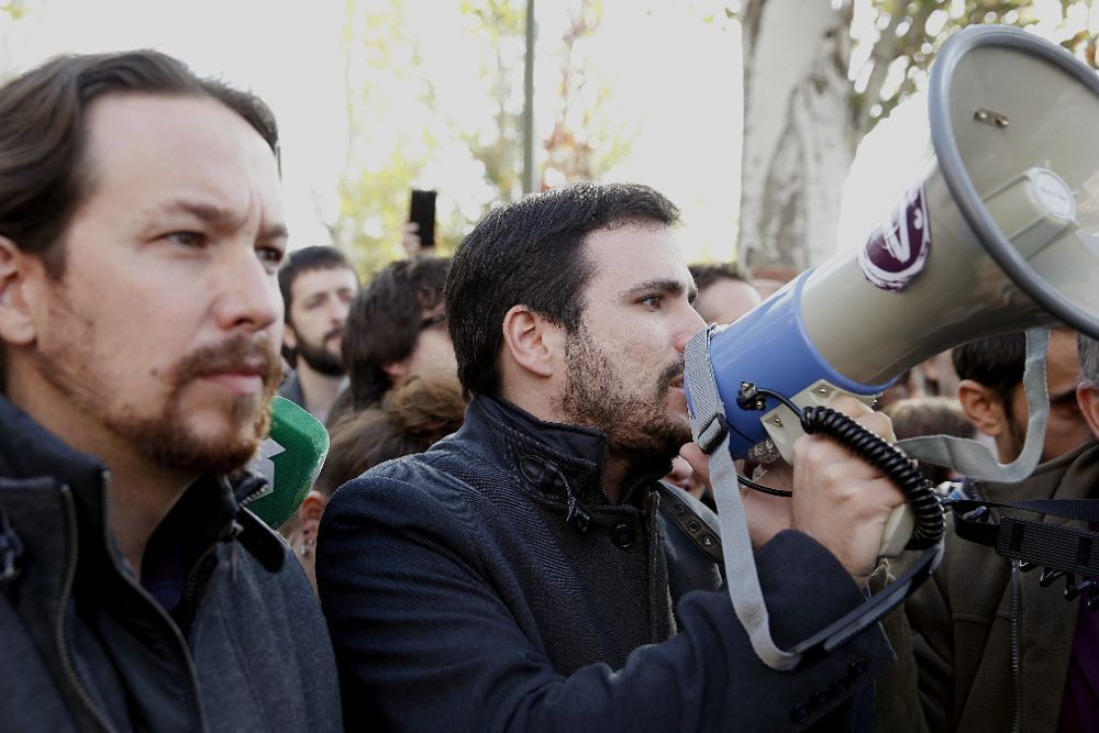 El secretario general de Podemos, Pablo Iglesias (i), y el coordinador federal de IU, Alberto Garzón (d), han paricipado hoy en la concentración "La pobreza energética mata. Nadie sin luz", frente a las oficinas de Gas Natural Fenosa.