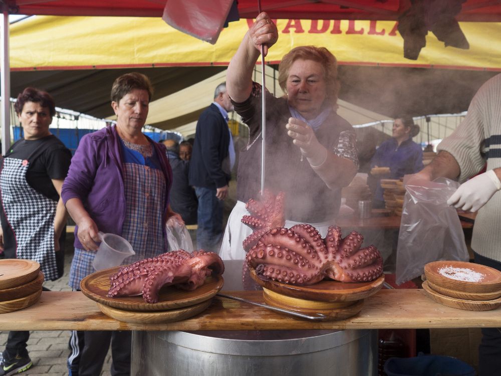 Unas pulpeiras preparan el plato típico de las ferias gallegas, en el municipio lucense de Monterroso.