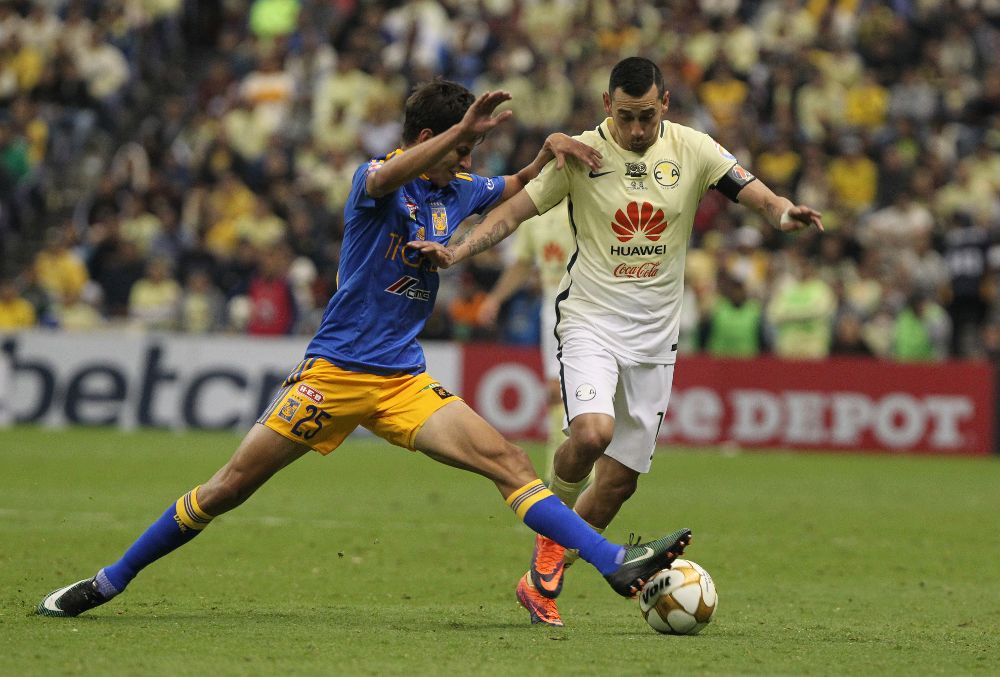 El jugador del América Rubens Sambueza (d) disputa un balón con Jurguen Damm (d) de Tigres.