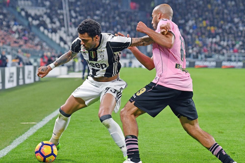 Dani Alves (i) en un partido de la Liga italiana entre el Juventus y el Palermo.
