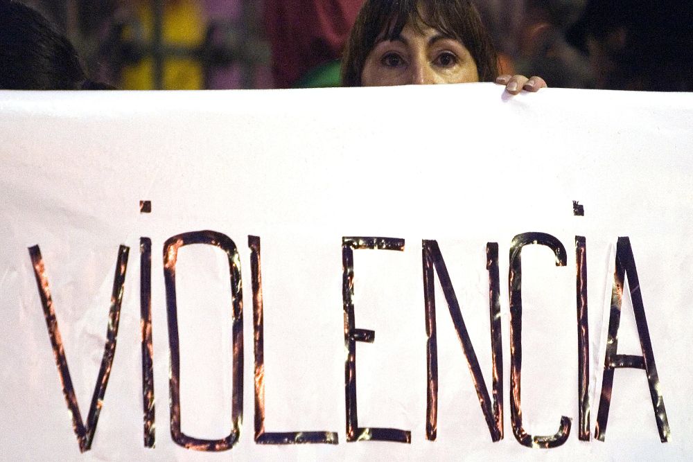 Una mujer sostiene la pancarta de la cabecera de la manifestación que hoy ha recorrido las calles de San Sebastián en denuncia de la violencia contra las mujeres, convocada por la Asociación contra la Violencia Doméstica y en Defensa del Menor (Acovidem).-