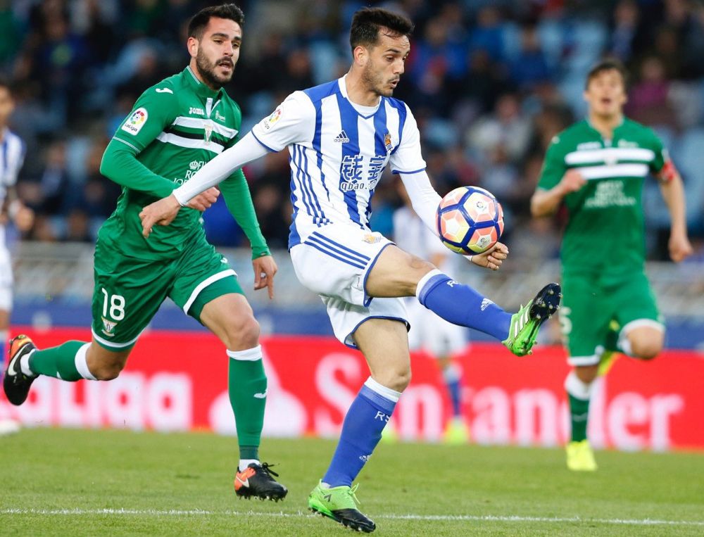 El delantero de la Real Sociedad, Juan Miguel Jiménez "Juanmi" (c), intenta controlar el balón ante el defensa del Leganés, Pablo Insúa.