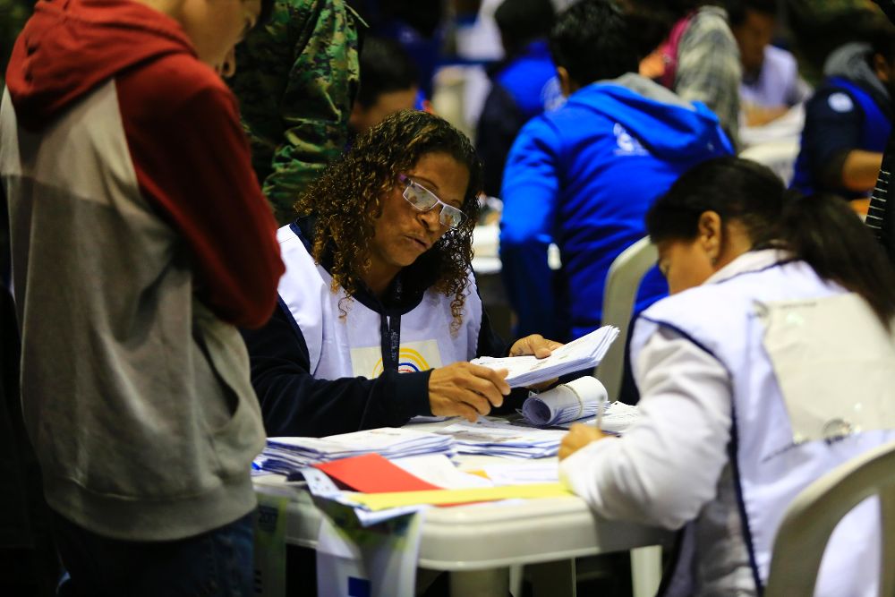 Funcionarios del Consejo Nacional Electoral (CNE) participan en el recuento de votos de la segunda vuelta.