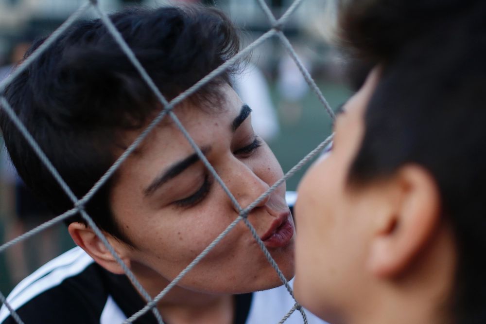 Dos jugadoras se besan antes de un partido del torneo de fútbol organizado por lesbianas y bisexuales.