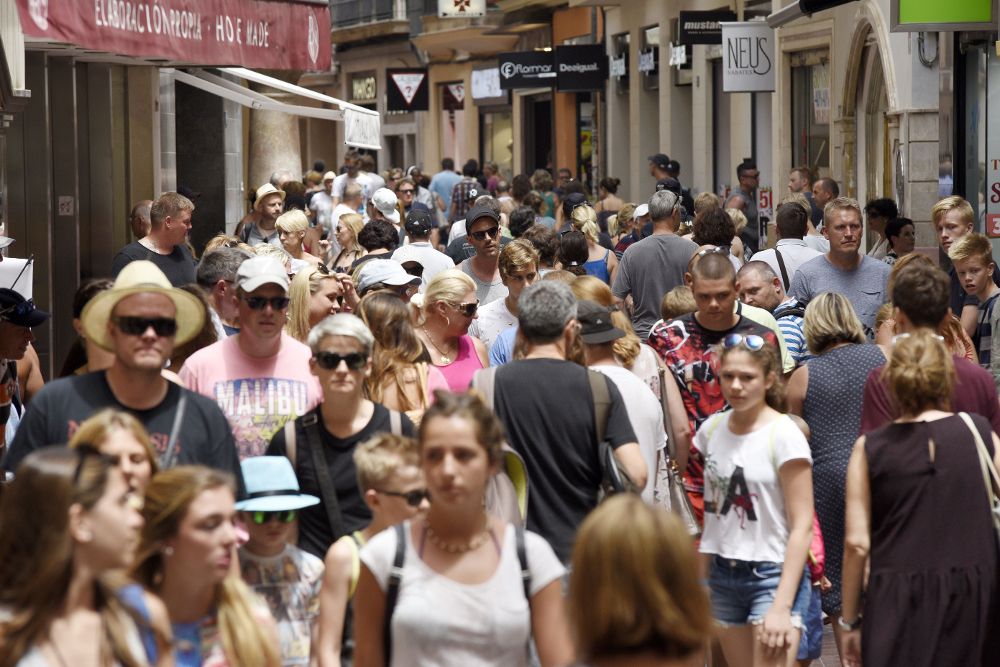 Turistas pasean por la céntrica calle de San Miguel en Palma. Más de dos millones de personas, casi el doble de su población habitual y 20 veces el aforo del estadio del Camp Nou, acogió Baleares el 9 de agosto de 2016, batiendo así un récord de masificación que puede ser superado este año.