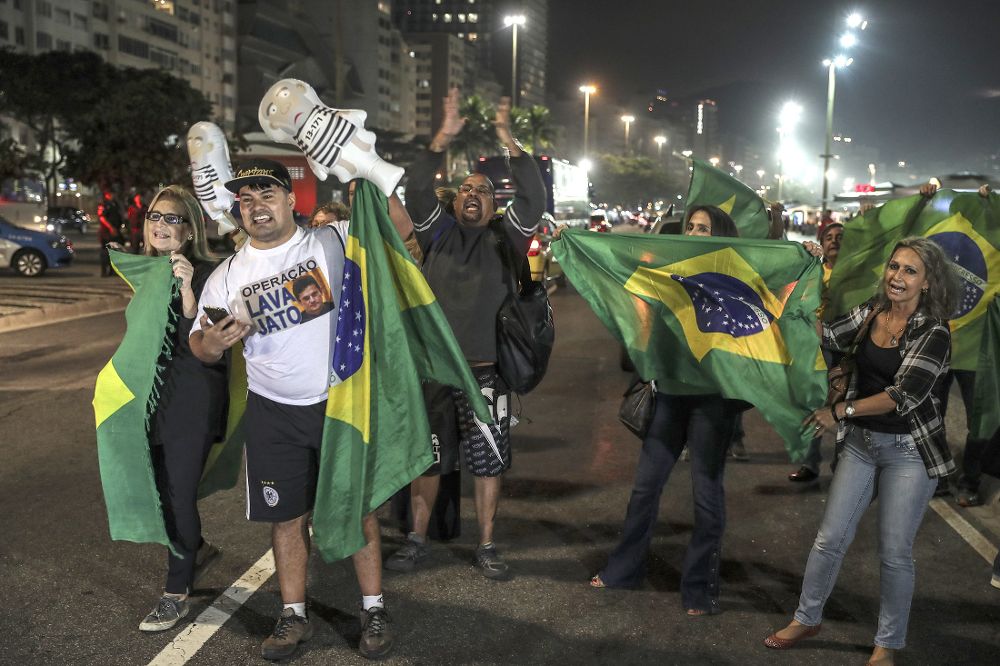 Un grupo de manifestantes participa en una concentración en la playa de Copacabana para celebrar la decisión del juez.