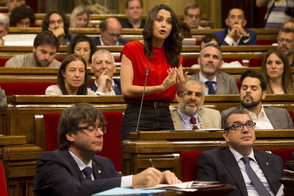 Una sesión del Parlament catalán. En primer término (iz), el presidente Puigdemont. De pie, la lider de Ciudadanos, Inés Arrimadas, le interpela durante una sesión de control.