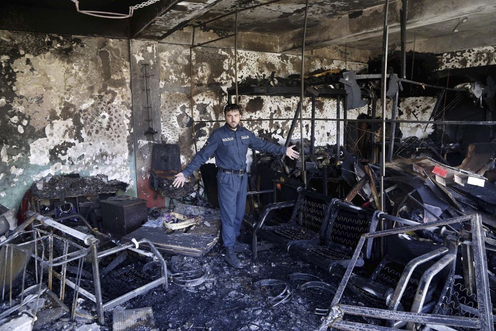 Un miembro de las fuerzas de seguridad inspecciona el lugar tras el atentado suicida perpetrado en Kabul.