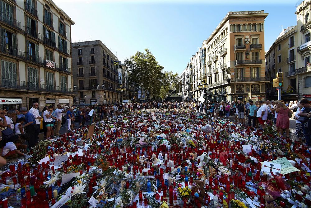 Cientos de personas se congregan en La Rambla de Barcelona, en el mosaico de Miró, lugar donde los ciudadanos depositan velas, flores y mensajes de apoyo y recuerdo a las víctimas del atentados.
