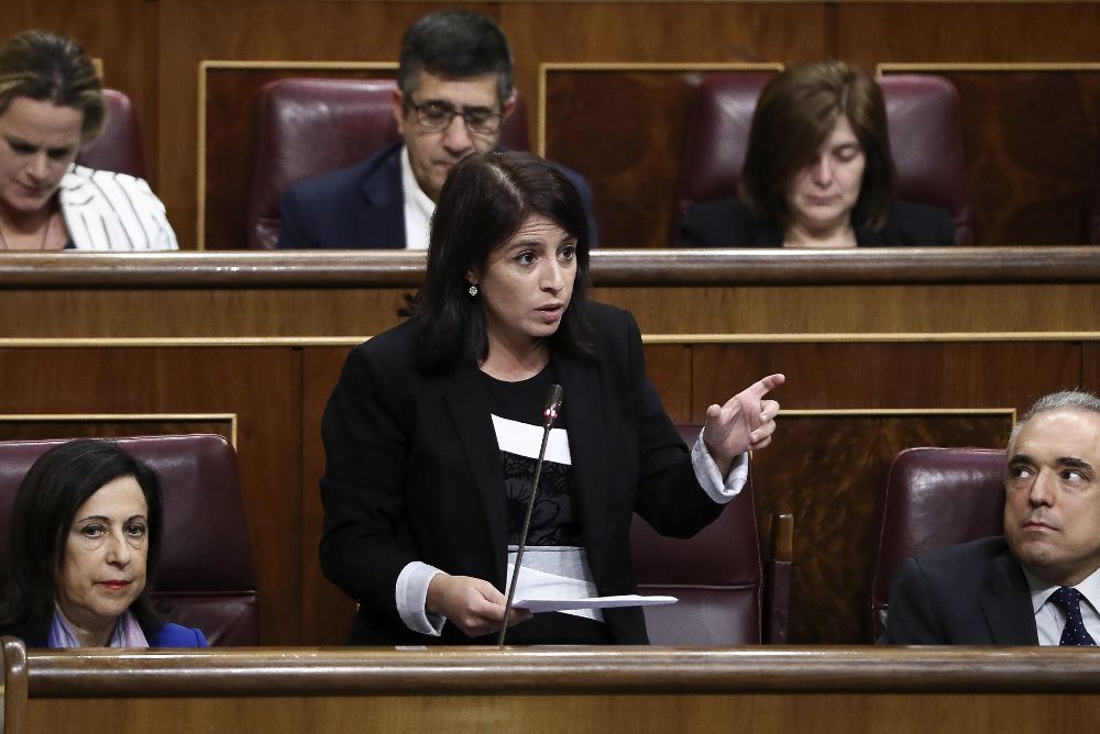 La diputada socialista Adriana Lastra interviente en el Congreso. A su lado, diputados de su grupo.
