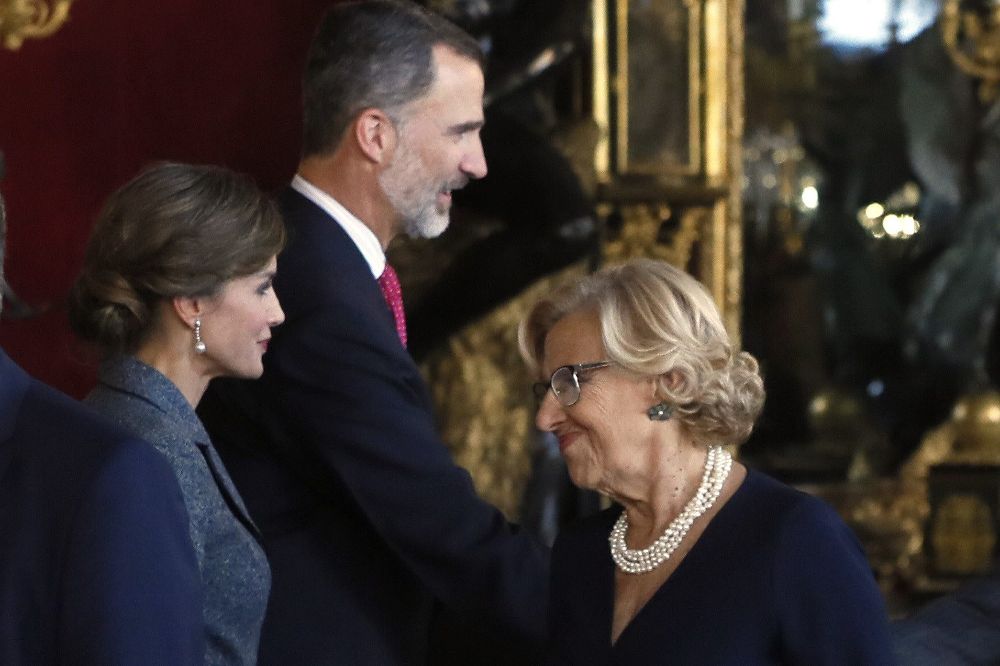 Los Reyes saludan a la alcaldesa de Madrid, Manuela Carmena, a su llegada a la tradicional recepción ofrecida este jueves en el Palacio Real con motivo del Día de la Fiesta Nacional.