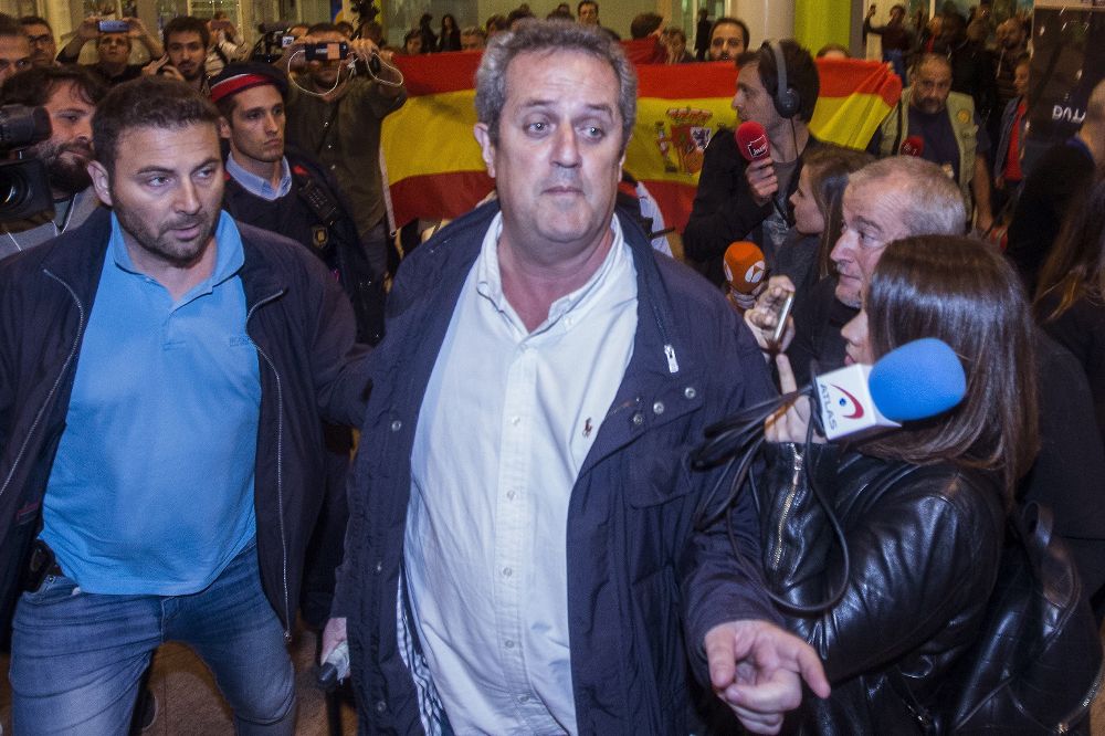 El exconseller de Interior, Joaquim Forn (c), a su llegada, anoche, al aeropuerto de Barcelona-El Prat procendente de Bruselas.