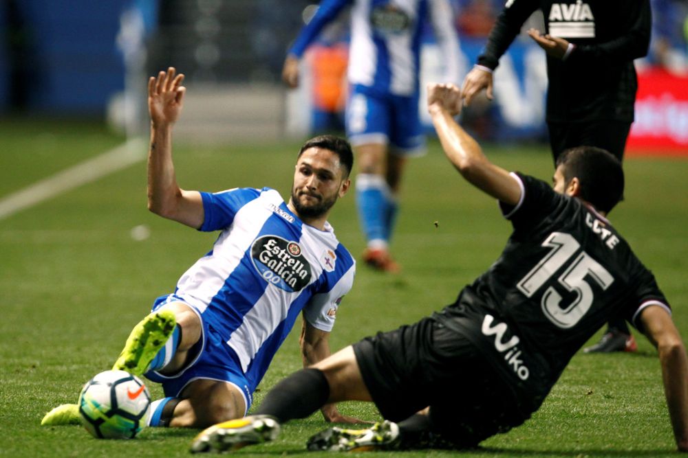 El delantero del Deportivo Florin Andone (i) lucha un balón con José Ángel "Cote", defensa del Eibar.