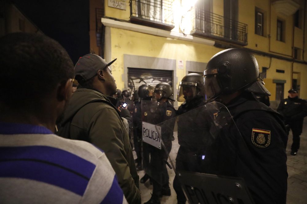 Policías antidisturbios intentan calmar la tensión en la calle Mesón de Paredes con la calle del Oso.